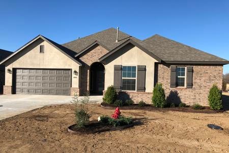 Finished custom home exterior by Timber Carver Homes